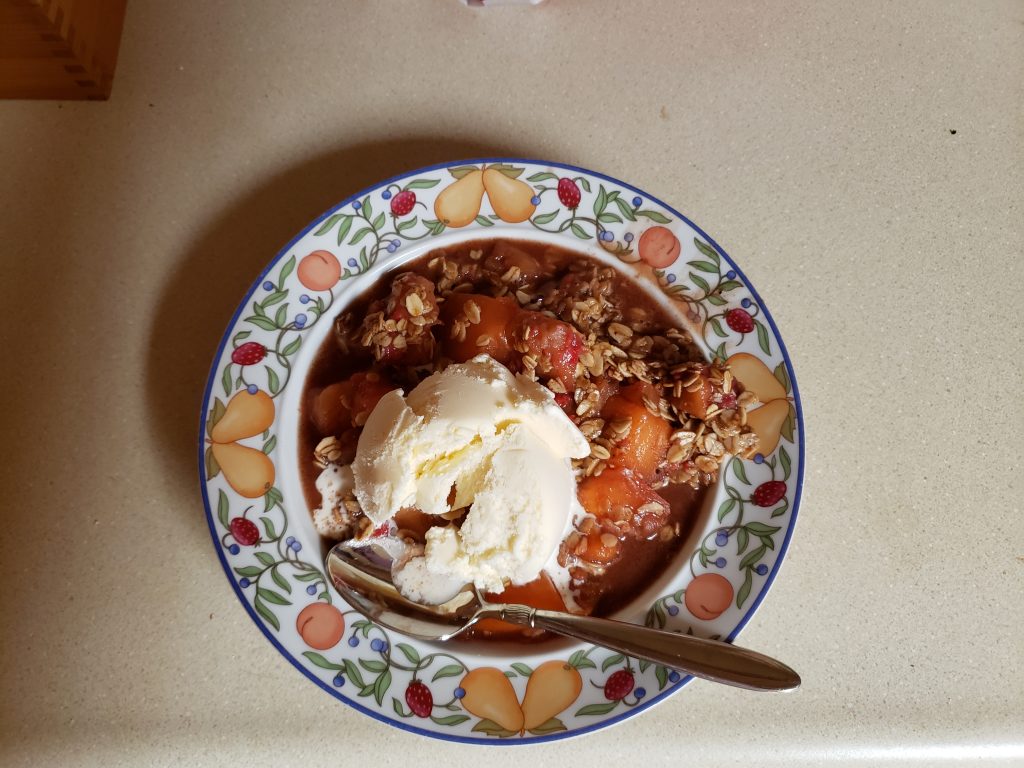 A photo of a bowl of apple-berry-oatmeal crisp