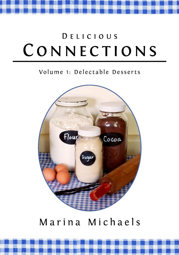 Front cover of Delicious Connections volume 1: Delectable Desserts. Has the title, author (Marina MIchaels), and a photo of jars of flour, sugar, and cocoa, with brown eggs, vanilla beans, and a rolling pin.